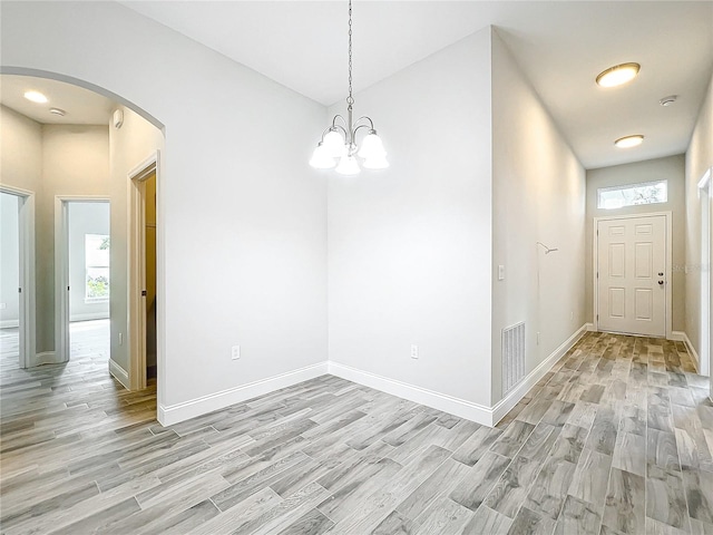 unfurnished dining area featuring light wood-type flooring