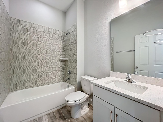 full bathroom with vanity, tiled shower / bath, wood-type flooring, and toilet