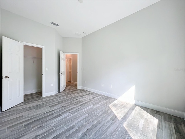 unfurnished bedroom featuring light hardwood / wood-style flooring and a closet