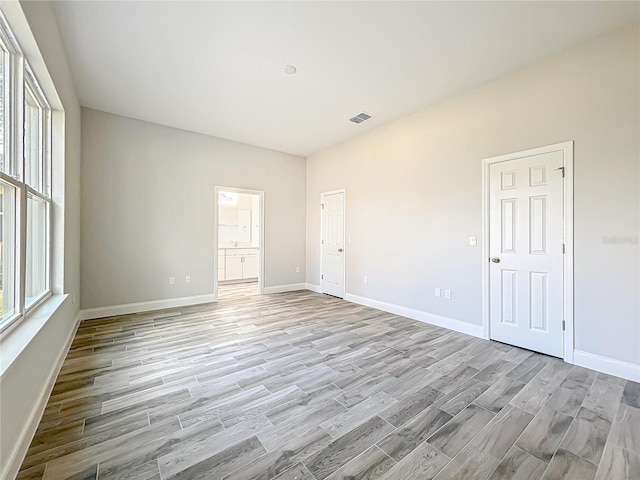 empty room with light hardwood / wood-style floors