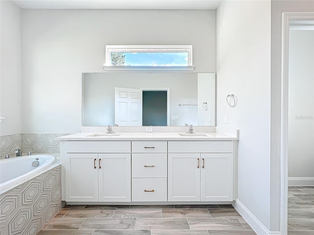 bathroom with vanity and a bath