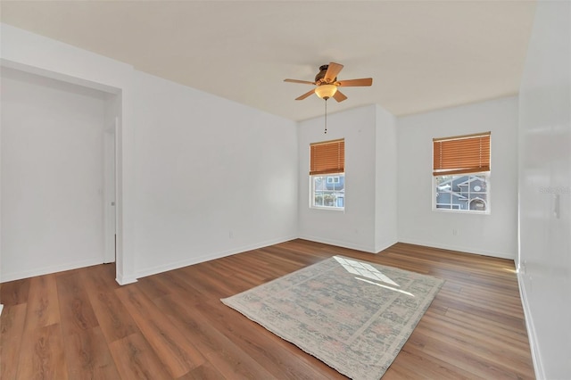 empty room featuring hardwood / wood-style floors and ceiling fan