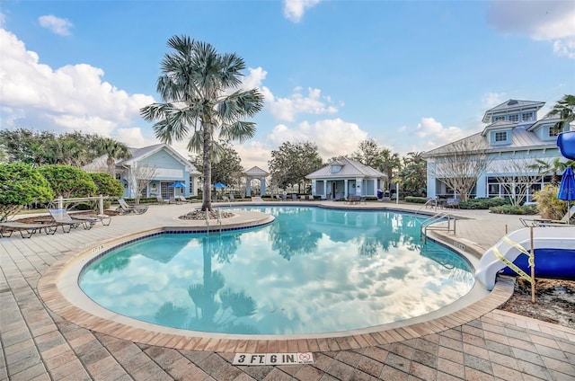 view of swimming pool featuring a patio area and a water slide