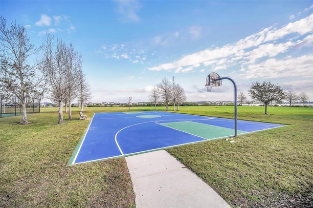 view of sport court featuring a lawn