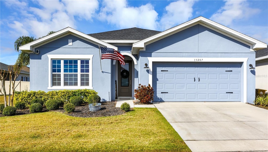 view of front of property with a garage and a front yard