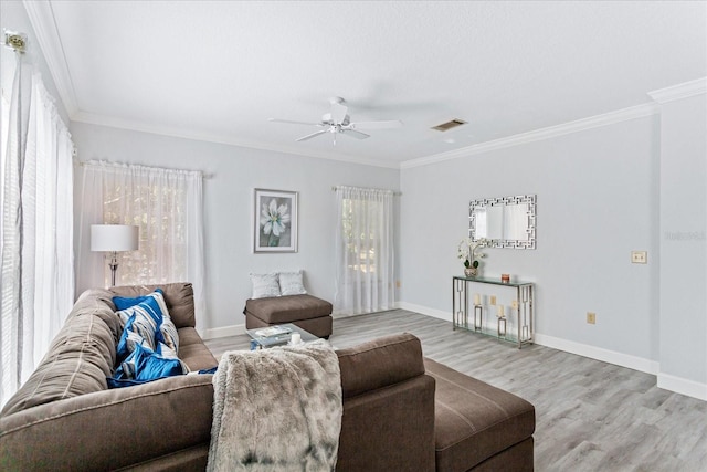 living room with hardwood / wood-style flooring, ornamental molding, and ceiling fan