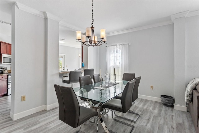 dining space featuring crown molding, a healthy amount of sunlight, and light hardwood / wood-style floors