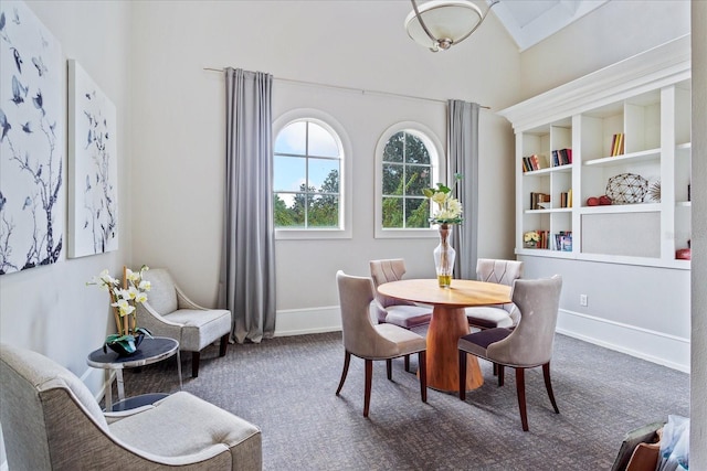 dining space featuring carpet floors and built in features