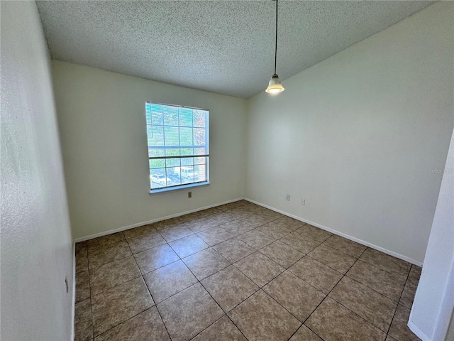 unfurnished room with tile patterned floors and a textured ceiling