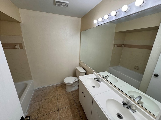 bathroom featuring vanity, tile patterned flooring, and toilet