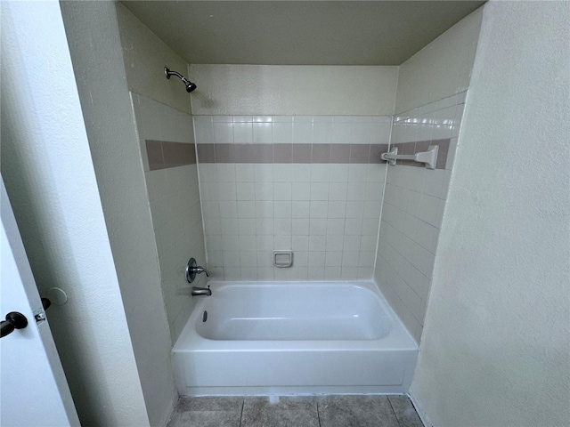 bathroom featuring tiled shower / bath combo and tile patterned flooring