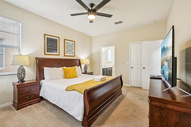 carpeted bedroom with ceiling fan and ensuite bathroom