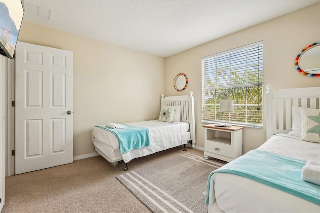 carpeted bedroom featuring a textured ceiling