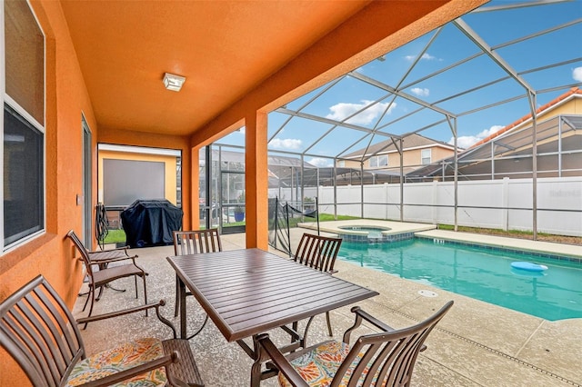 view of swimming pool with an in ground hot tub, a lanai, grilling area, and a patio area