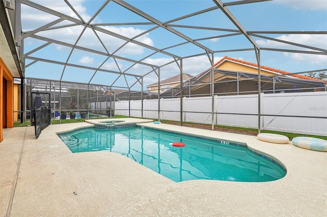 view of swimming pool featuring an in ground hot tub, a patio, and glass enclosure