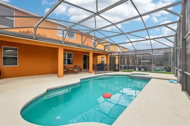 view of swimming pool featuring an in ground hot tub, a lanai, and a patio