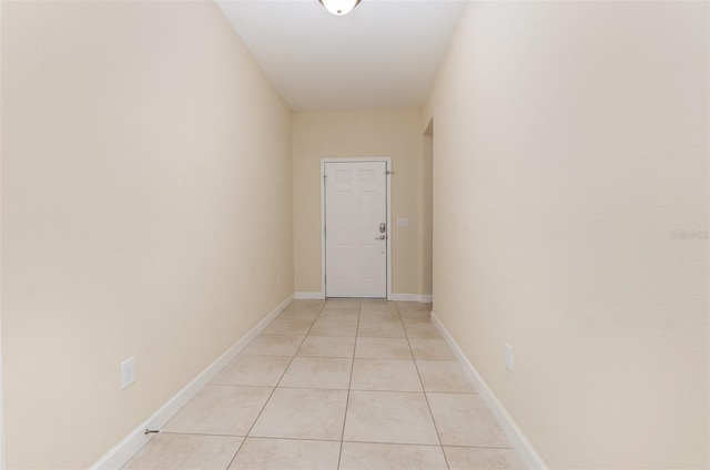 hall with light tile patterned floors