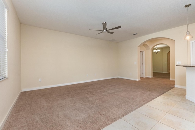 carpeted spare room with a textured ceiling and ceiling fan