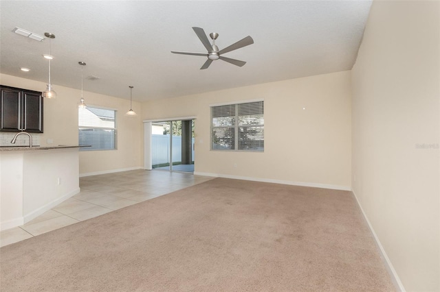 spare room featuring light carpet and ceiling fan