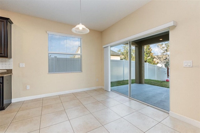 unfurnished dining area with light tile patterned floors