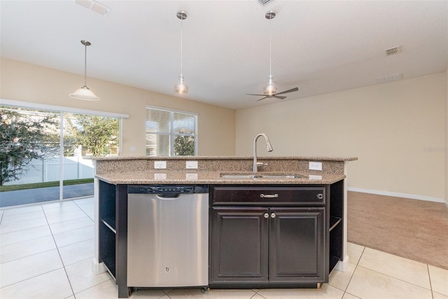 kitchen with stainless steel dishwasher, decorative light fixtures, sink, and a center island with sink