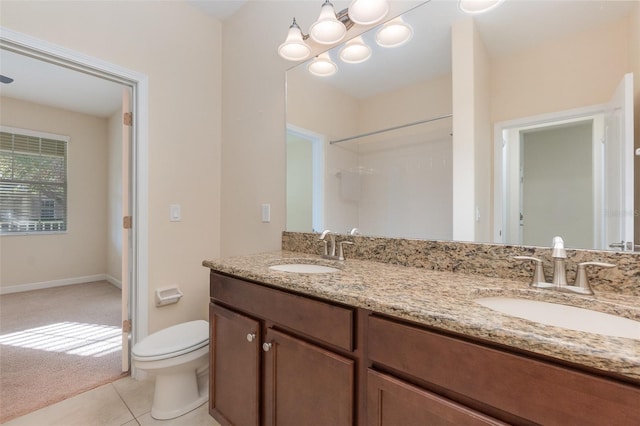 bathroom with vanity, tile patterned floors, and toilet