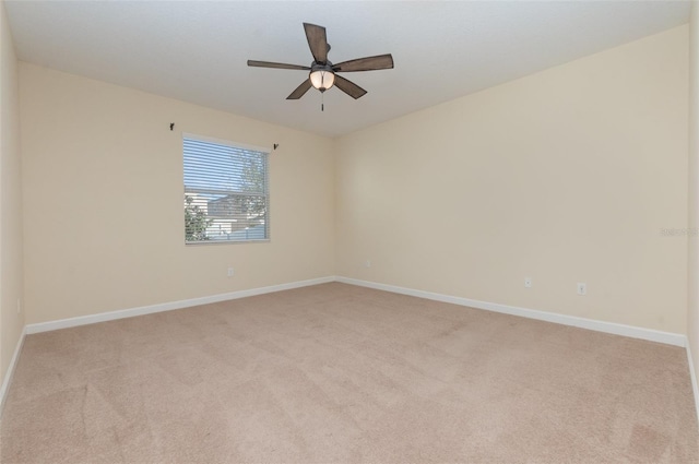 empty room with light colored carpet and ceiling fan