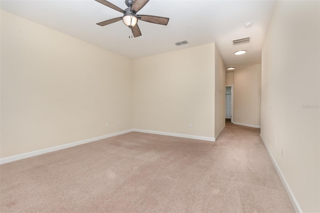 unfurnished room with light colored carpet and ceiling fan