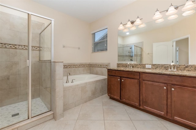 bathroom with tile patterned flooring, shower with separate bathtub, and vanity