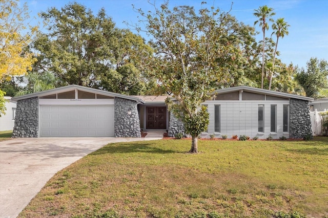 single story home with a garage and a front lawn