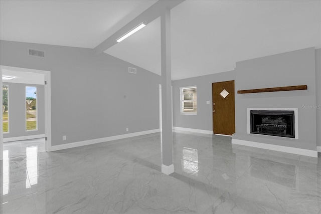 unfurnished living room featuring beamed ceiling, plenty of natural light, and high vaulted ceiling