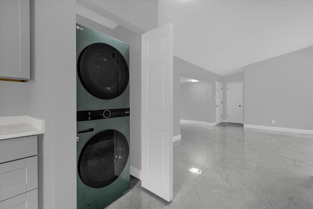 clothes washing area with stacked washer / dryer