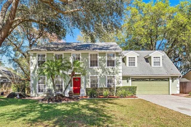 colonial house featuring a garage and a front yard