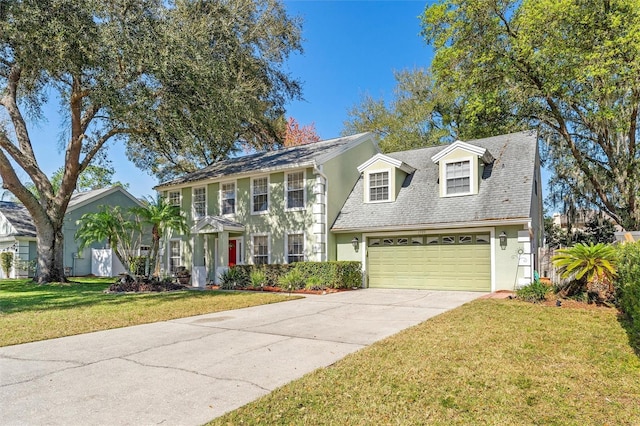 view of front of house with a garage and a front lawn