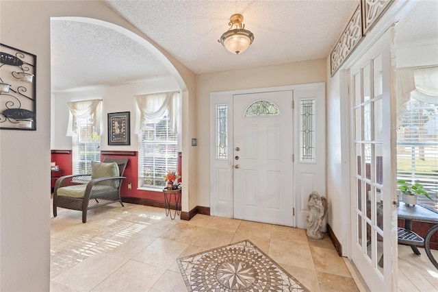 tiled entrance foyer with a textured ceiling