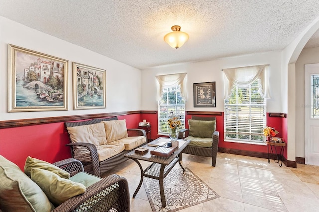 sitting room with light tile patterned flooring and a textured ceiling