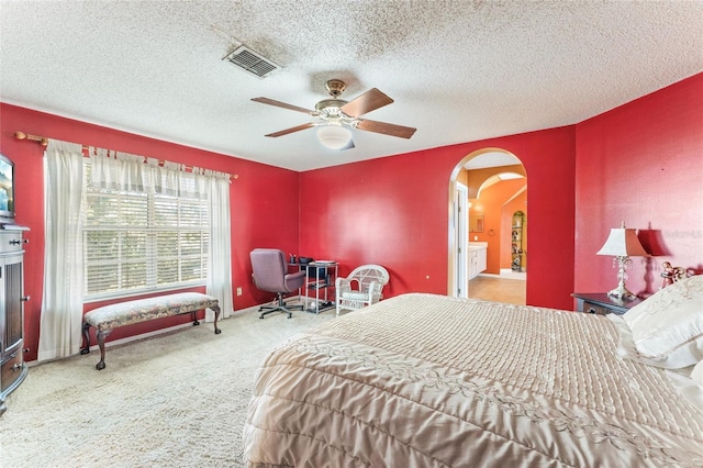 carpeted bedroom featuring a textured ceiling and ceiling fan