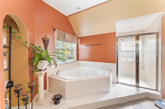 bathroom with vaulted ceiling, tile patterned floors, and plus walk in shower