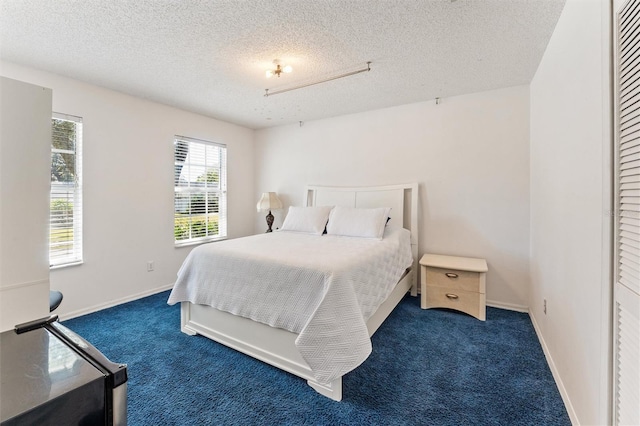 carpeted bedroom with a textured ceiling