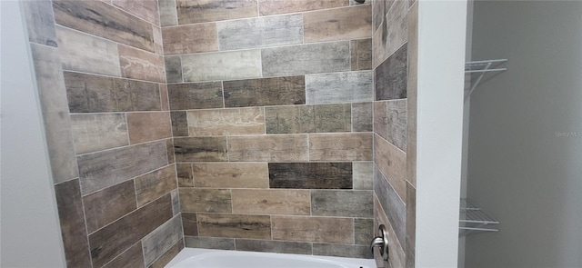 full bathroom featuring a spacious closet and shower / tub combination