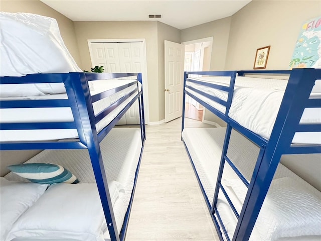 bedroom featuring hardwood / wood-style flooring and a closet