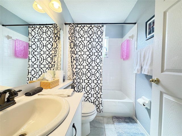 full bathroom featuring tile patterned floors, toilet, a textured ceiling, vanity, and shower / bath combo with shower curtain