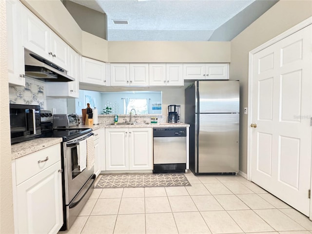 kitchen featuring white cabinetry, appliances with stainless steel finishes, sink, and light tile patterned floors