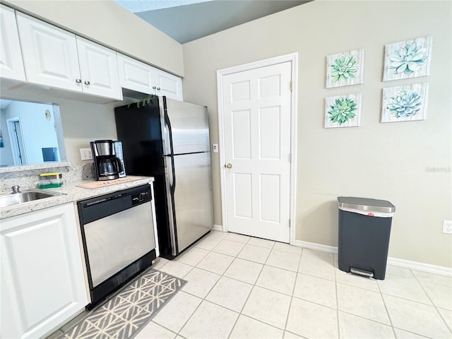 kitchen featuring light tile patterned floors, sink, white cabinets, and appliances with stainless steel finishes