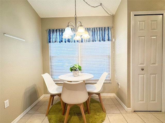 tiled dining space with lofted ceiling and a chandelier