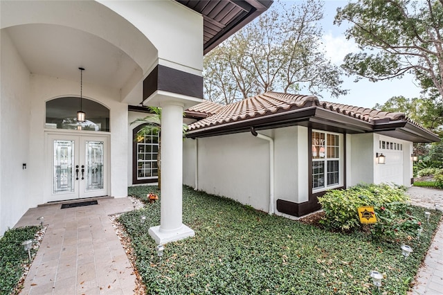 entrance to property with french doors and a garage