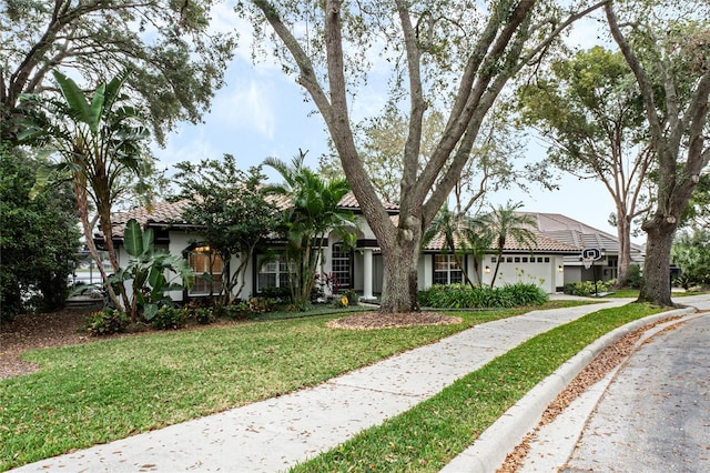 view of front of house featuring a front lawn and a garage