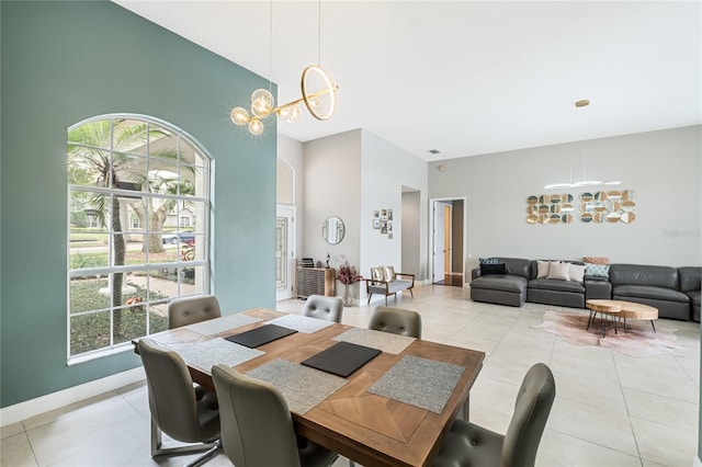 dining area with light tile patterned flooring, an inviting chandelier, and plenty of natural light