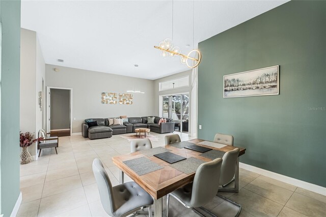 tiled dining room with an inviting chandelier