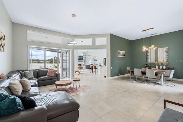 living room featuring a notable chandelier and light tile patterned floors